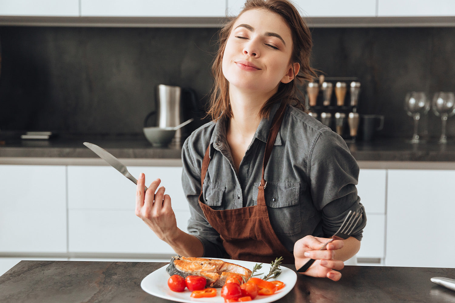 Smiling woman enjoying a healthy meal in the kitchen