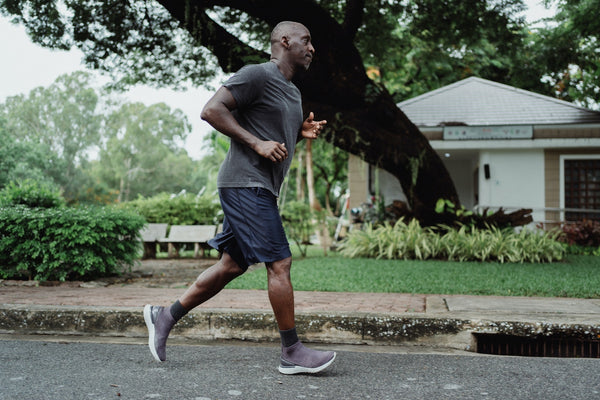 Man jogging in a park, staying fit and healthy.